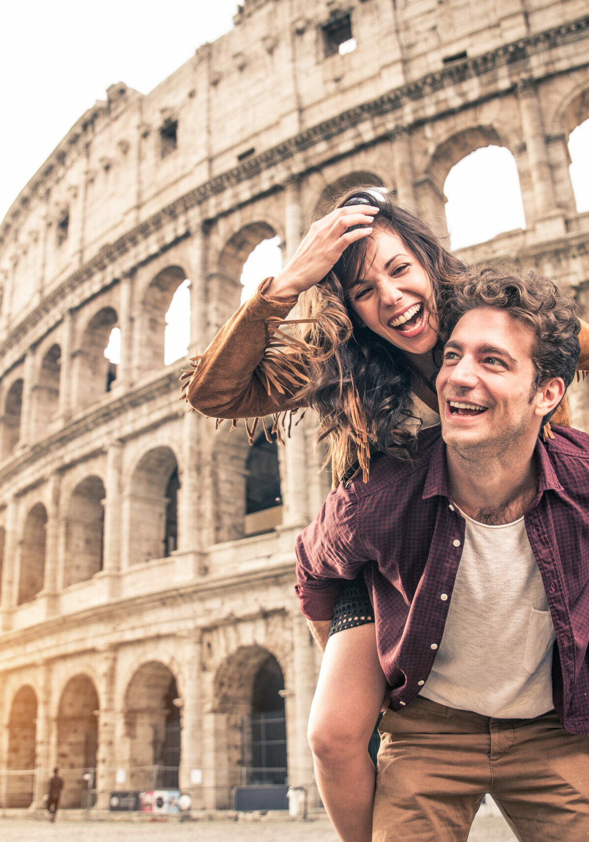 Young,Couple,At,The,Colosseum,,Rome,-,Happy,Tourists,Visiting