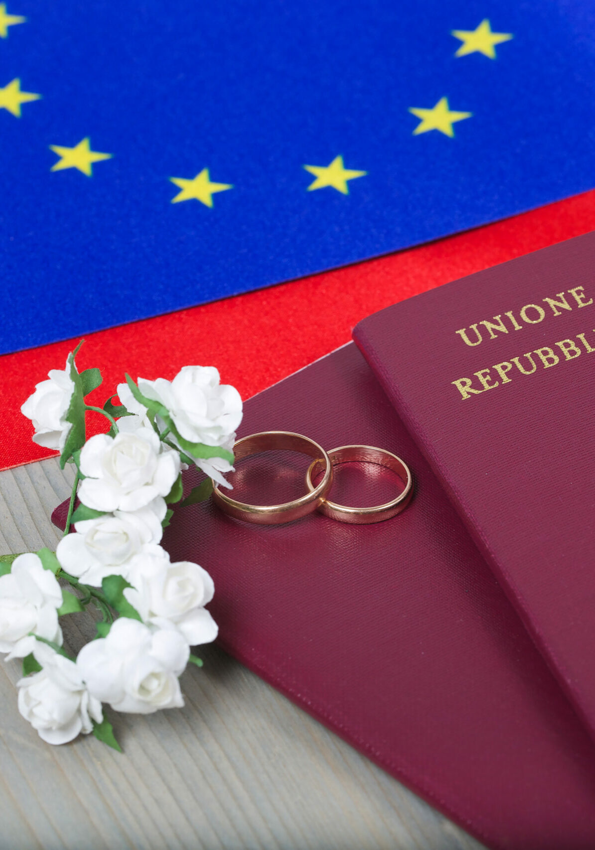 Marriage,Rings,paper,Flowers,And,Two,Passports,Close,To,The,Flags
